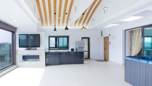 A modern kitchen with a large island, built-in appliances, and a large window. - Pool Villa Linderburg (Taean)