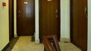 A hallway with three wooden doors, each marked with a number. - Hotel Ruza Nepal (Kathmandu)