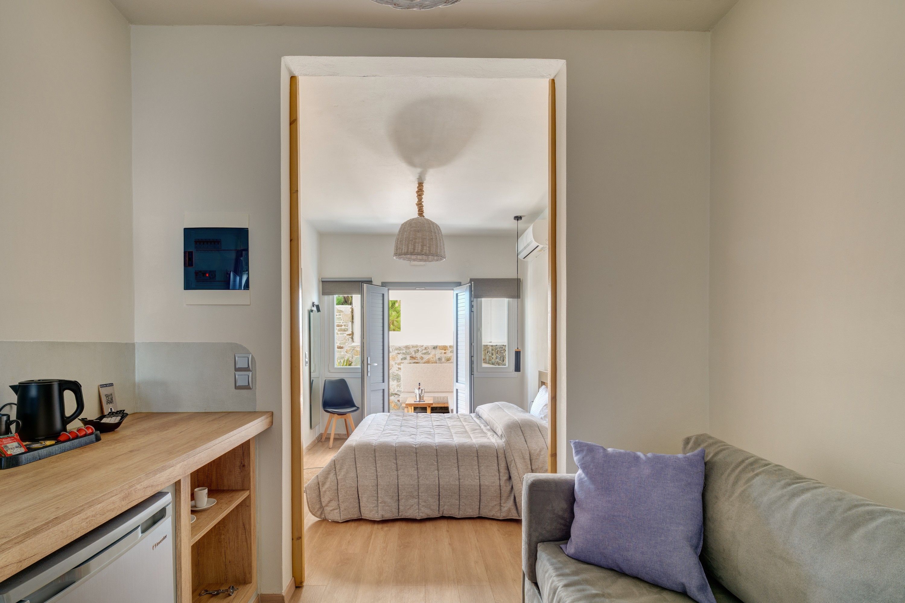 A compact room with a bed, a desk, and a chair.