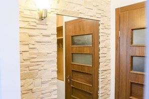Stunning hallway with a stone wall and a door with frosted glass panels.