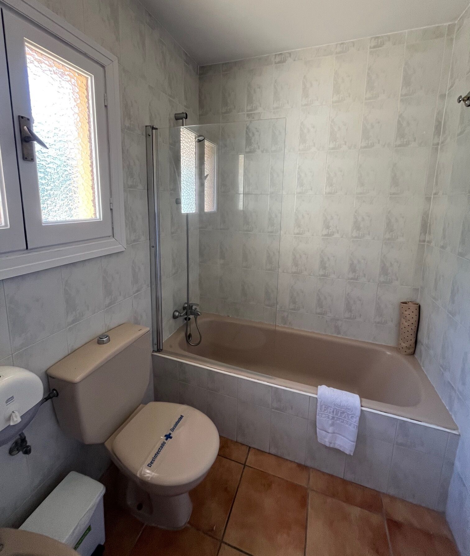 A bathroom with a toilet, a shower, and a bathtub.