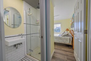 Bathtub, hair dryer, towels, toilet paper