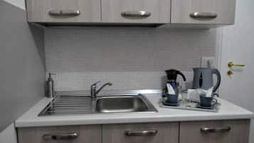 Fridge, electric kettle, cookware/dishes/utensils