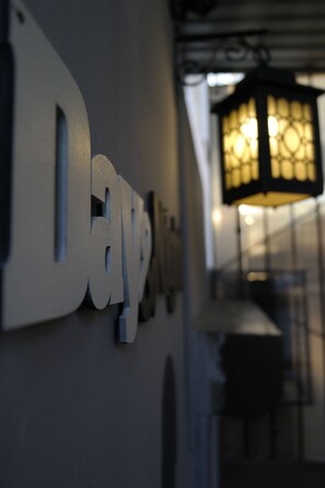 A close-up of a wall-mounted sign with the word "Day" partially visible.