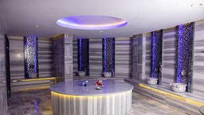 A modern bathroom with a central circular sink, marble walls, and blue LED lighting accents. - Anemon Kent Mersin Hotel (Mersin)