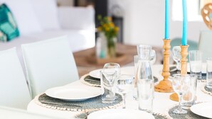 A dining table set with plates, glasses, and candles. - Yellow Dream Villas (Chania)