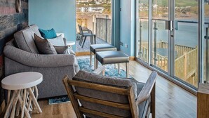 A modern living room with a view of a waterfront.