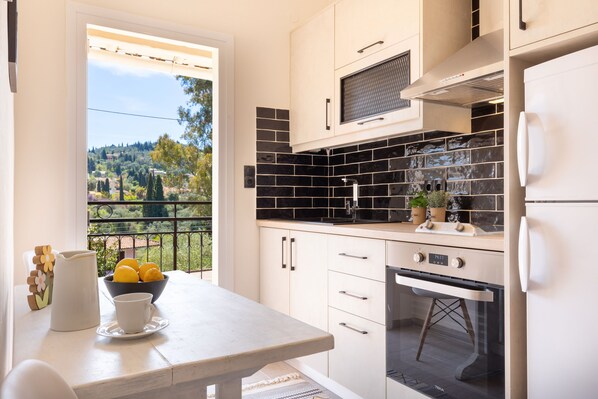 Apartment, 2 Bedrooms | Private kitchen | Fridge, stovetop, coffee/tea maker, electric kettle - Ipsos Pool Apartments, Elena & Maria by Konnect (Corfu)