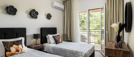 A hotel room with two beds, a balcony, an air conditioning unit, and a decorative vase.