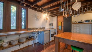 Kitchen features a stainless steel sink, dishwasher, and microwave, with ample space for cooking and dining.