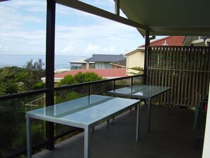 Outdoor dining - STRATHMORE LODGE  UNIT 1. UPPER LEVEL. Spectacular views of Lighthouse Beach. (Port Macquarie)