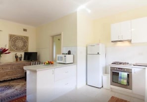 A compact kitchen with white cabinets, a microwave, a refrigerator, and a stove. - B5 Crawley/Nedlands Apartment 1 BRM + Sleepout - 2min walk to UWA (Crawley)