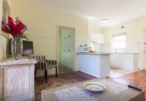 A compact living space with a dining area, a kitchen, and a small seating area. - B5 Crawley/Nedlands Apartment 1 BRM + Sleepout - 2min walk to UWA (Crawley)