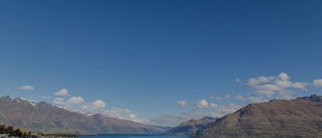 A lakeside town with mountains in the background.