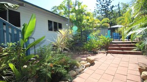 A house with a brick pathway leading to a set of stairs. - Magnetic Dreams Unit 1 (ARCADIA)