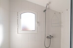 Shower, hair dryer, towels, toilet paper