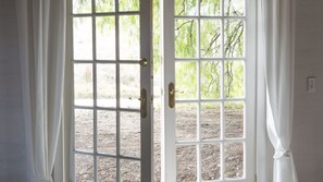 A white door with a grid pattern and a brass handle.