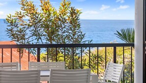 Relax on the balcony with ocean views, a perfect spot for dining or unwinding.