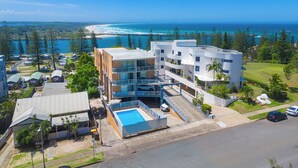 A resort with multiple buildings, a swimming pool, and a view of the ocean. - HEADLANDS 2: 2  BR, 1  BA Apartment in Port Macquarie, Sleeps 4 (Port Macquarie)
