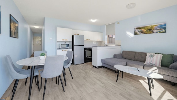 A modern apartment with a dining area, kitchen, and living space. - HEADLANDS 2: 2  BR, 1  BA Apartment in Port Macquarie, Sleeps 4 (Port Macquarie)