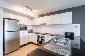 Fridge, microwave, oven, stovetop - "Summercloud" - Huge Premium 2BR Apt on Huskisson Main Street, By Nautilus Apartments Jervis Bay (Huskisson)
