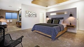 A modern bedroom with a large bed, a wooden ceiling, and a wall-mounted artwork. - C`est La Vie – Elite Holiday Homes (Gold Coast)
