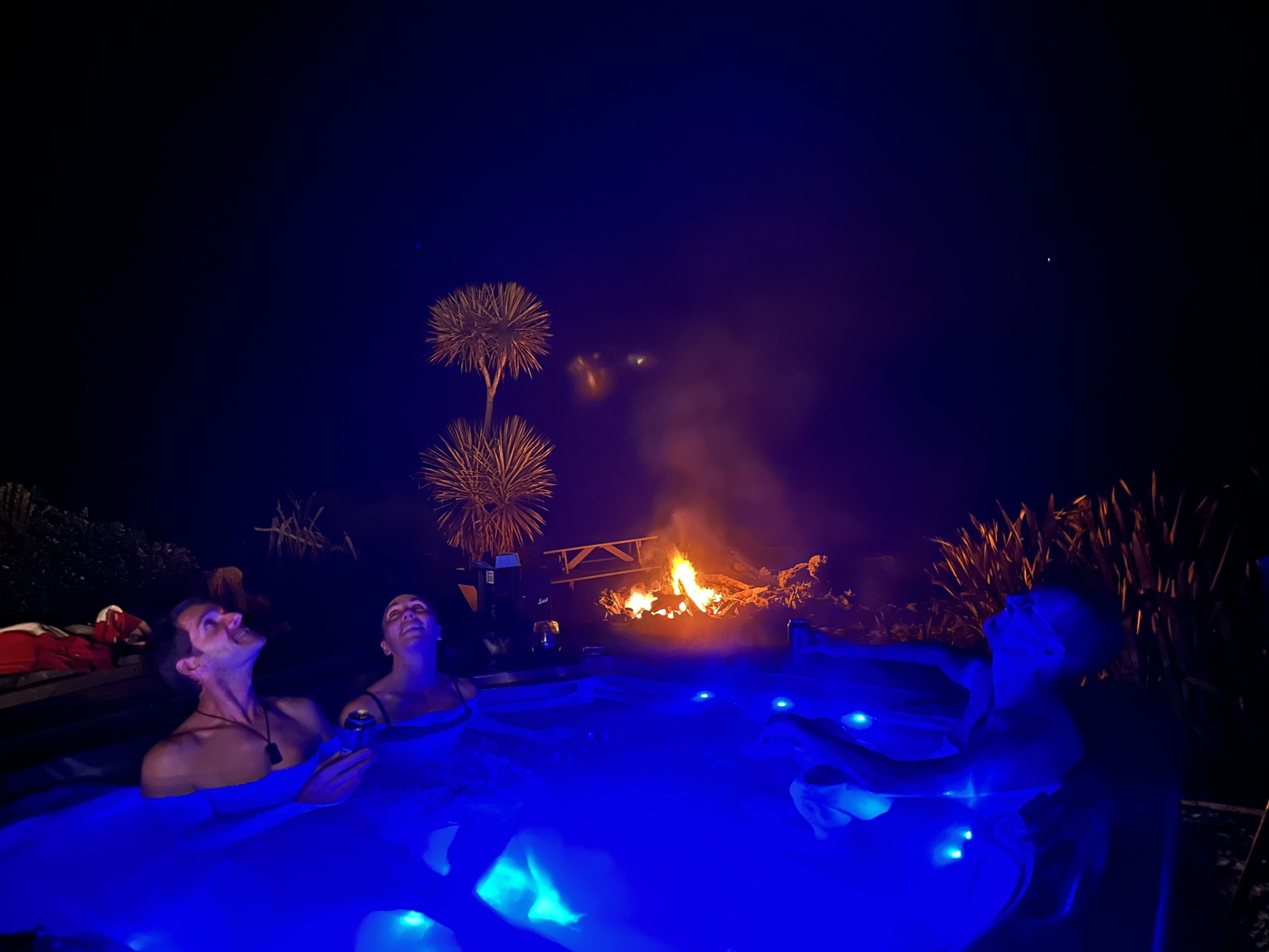 Soak under the stars while the fire glows nearby - a dreamy combo of warmth, laughter, and good company.