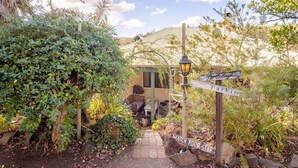 A pathway leading to a building labeled 'The Cottage' with a sign indicating 'Parkin' and a 'WATCH YOUR STEP' warning. - Bickley Valley Cottage (Bickley)