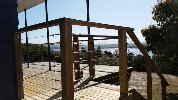 A wooden deck with a metal railing overlooking a body of water. - API Leisure & Lifestyle St Helens (St Helens)