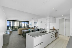 Enjoy a panoramic city view from the large window in this apartment's spacious living area.