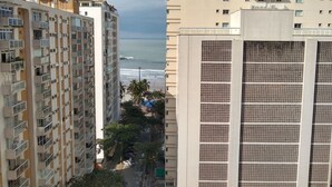 A high-rise building with multiple balconies and a view of the ocean. - Guaruja, Pitangueiras beach, flat with services. (Guarujá)