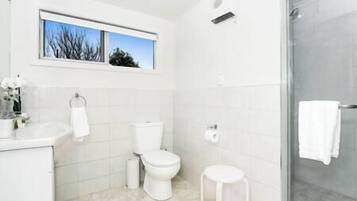Un baño moderno con inodoro, bidé y ducha.