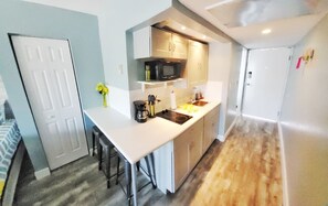 Comfort Studio, 2 Queen Beds, Kitchen, Partial Ocean View | Private kitchen | Mini-fridge, toaster, cookware/dishes/utensils, paper towels - Daytona Inn Studios (Daytona Beach)