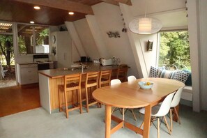 View into the kitchen area with breakfast bar for 4