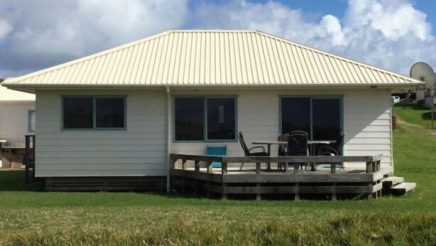 A small, single-story building with a flat roof and a covered porch area. - Seabed Bach Tokerau Beach (Karikari Peninsula)