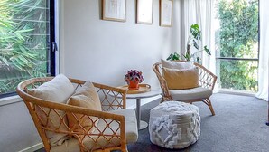 A room with wicker furniture, a round table, and a potted plant. - Reconnect Your Mind, Body and Soul... (Wongawallan)