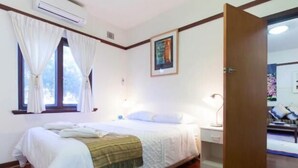 A bedroom with a bed, a nightstand, a lamp, and a window with curtains. - B4 UWA, Swan River, Hospitals, CBD (Crawley)