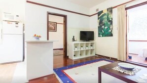 A compact living space with a kitchen area, a television, and a dining table. - B4 UWA, Swan River, Hospitals, CBD (Crawley)