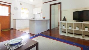 A modern kitchen with white cabinets, a wooden countertop, and a built-in oven. - B4 UWA, Swan River, Hospitals, CBD (Crawley)