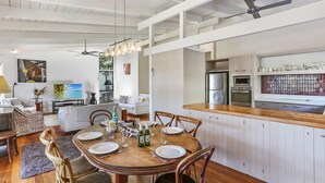 Una cocina amplia con una isla de madera, electrodomésticos de acero inoxidable y salpicadero de azulejos.