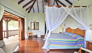 A spacious bedroom with a large bed, wooden ceiling beams, a desk, and a chair. - Tivigny Villa: Unwind and Disconnect from the Stress in this Costal Villa (Woburn)