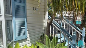A house with a number 37A on the side, a blue window shutter, and a staircase with white balusters. - Bromyard Lakeside Cottage - access to waterfront (Swansea)