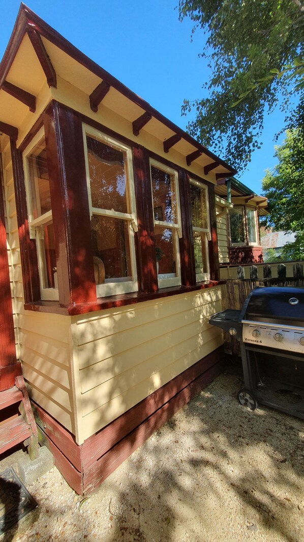A house with a porch, large windows, and a grill. - Blackwood Cobb & Co Historic Forest Retreat (Blackwood)