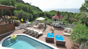 A pool area with lounge chairs, a gazebo, and a view of the ocean. - Sea view, fully staffed villa for Families & Retreats, groups of 9 - 20 guests (Cap Estate)