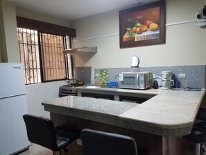 Fridge, microwave, stovetop, coffee/tea maker