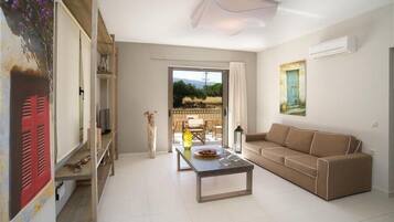 Deluxe Apartment, 2 Bedrooms | Living room | Flat-screen TV