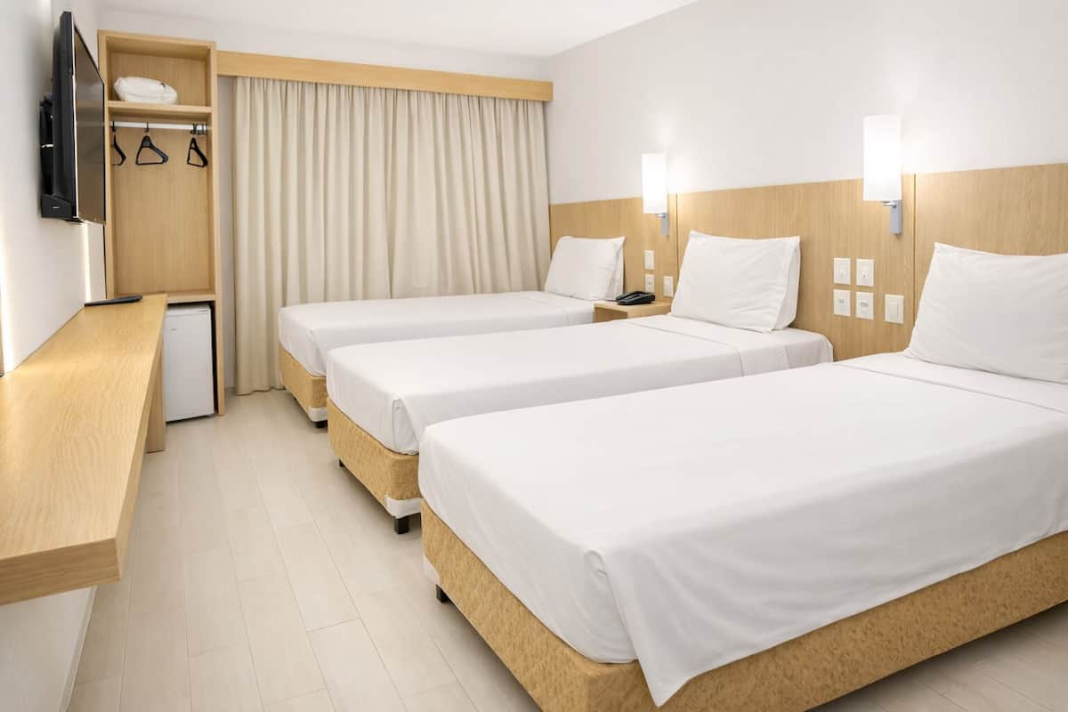 Standard Triple Room | Minibar, desk, laptop workspace, blackout curtains