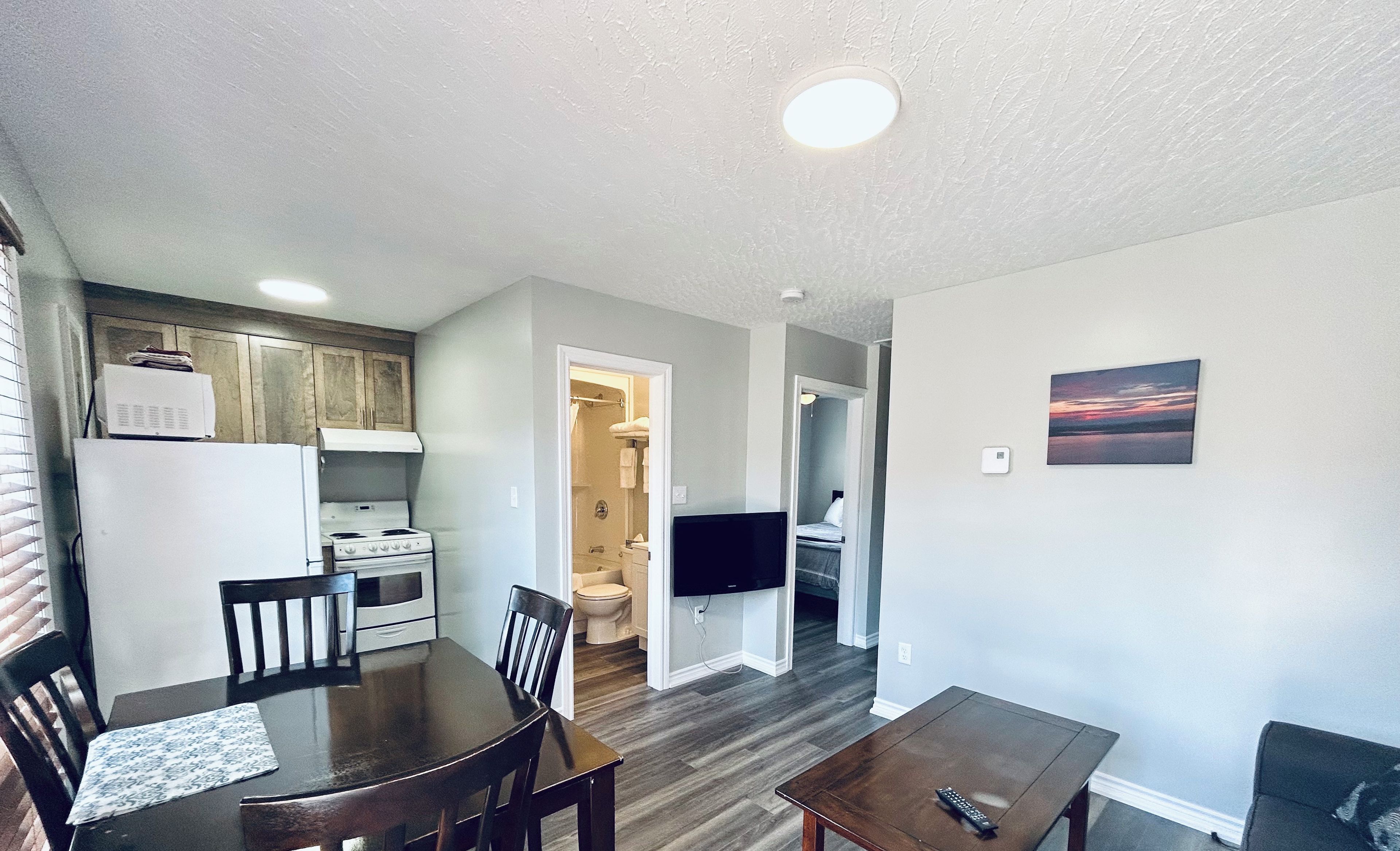 A two-bedroom cottage with a kitchen, dining area, and living room.