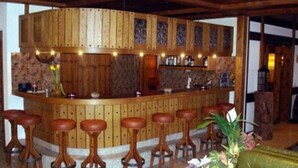 A bar area with wooden bar stools and a counter. - City Hotel Haupthaus and Nebenhaus (Taesch)