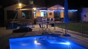 A backyard with a pool, patio furniture, and string lights. - IDEAL FAMILY BEACH GETAWAY, 1 HR FROM SYDNEY!!! (Umina Beach)